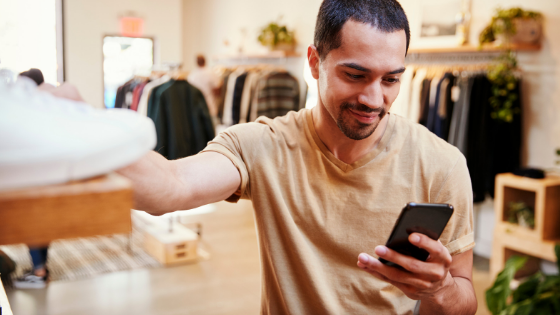 man shopping and looking at phone