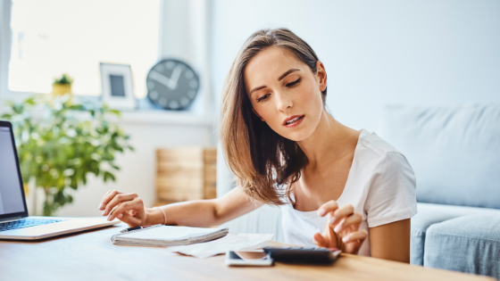 Young woman using calculator