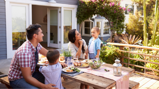 Family eating a meal in backyard