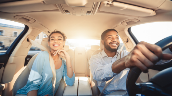 couple driving new car