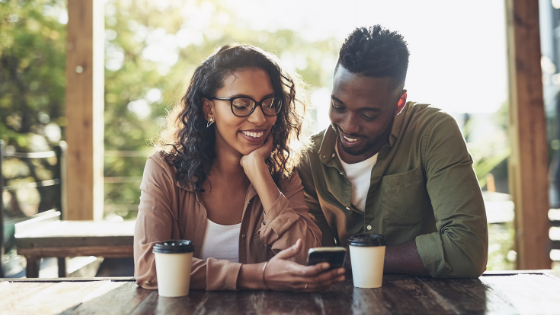 Smiling couple looking at a phone